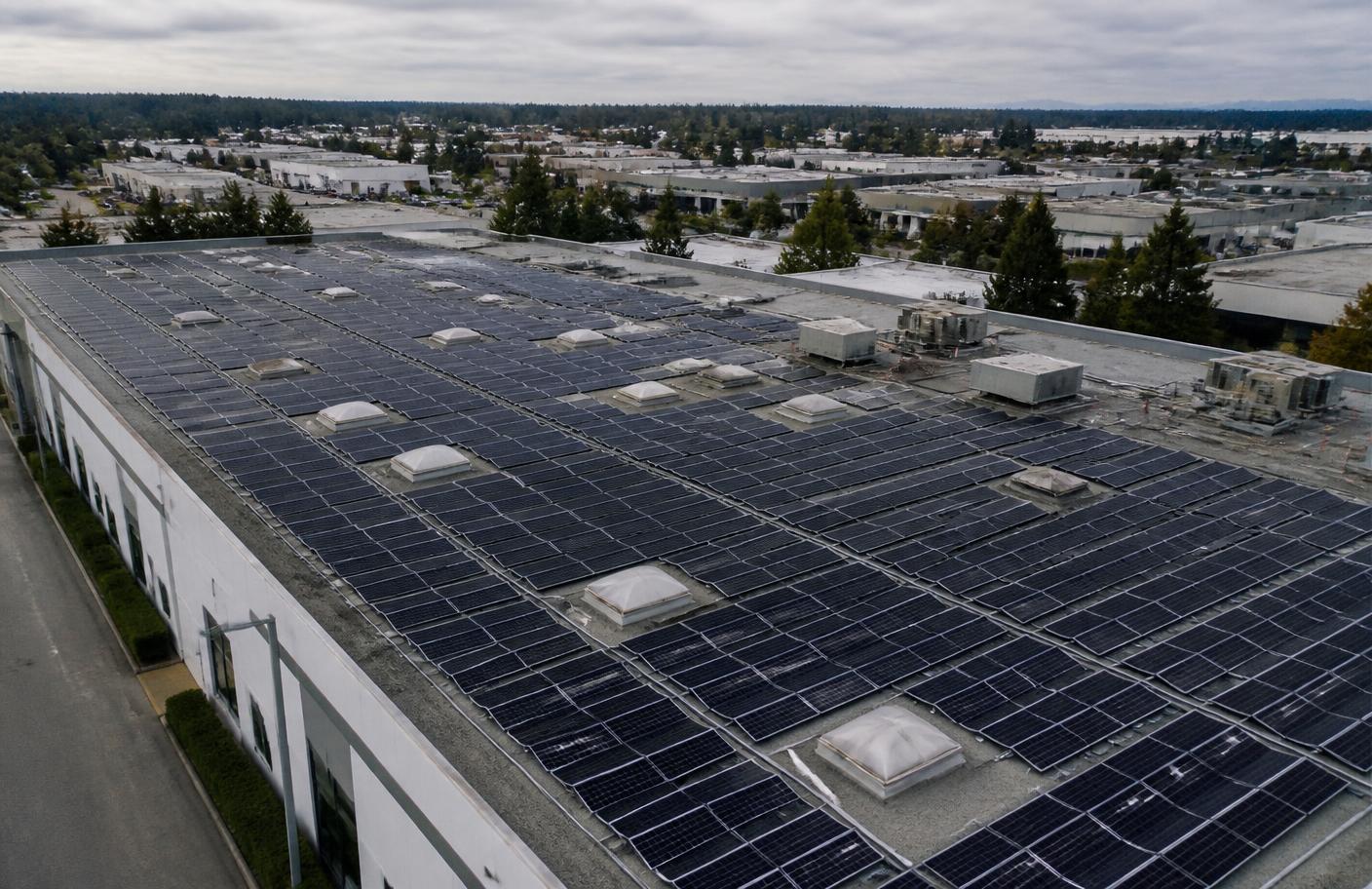 Aerial view of a 250 kW rooftop solar array on a commercial building in Surrey, BC